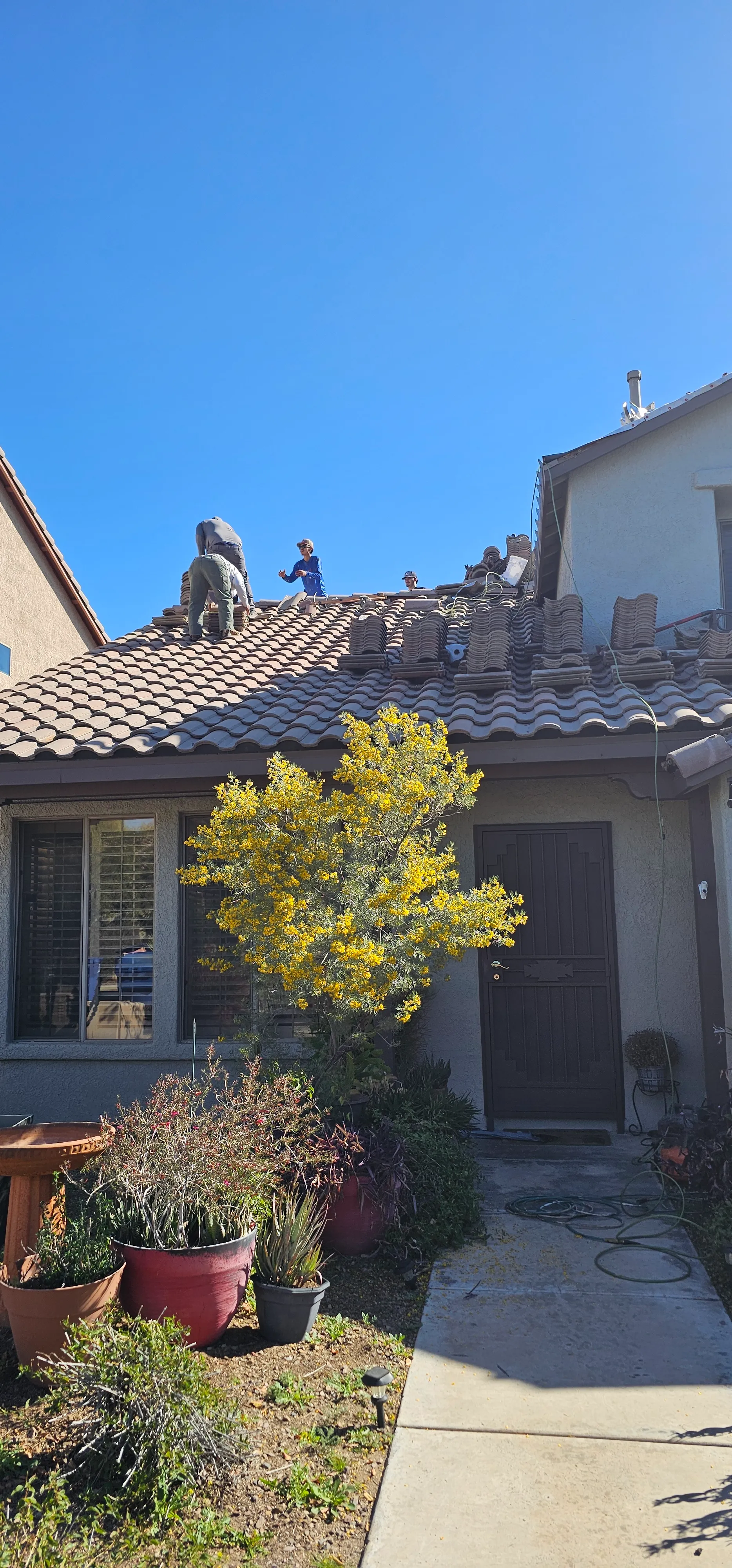 DC Roofing of Arizona crew working on a tile roof replacement in Tucson