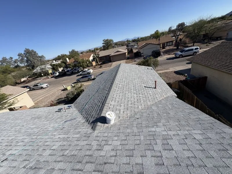 Aerial view of completed gray shingle roof replacement on Tucson home