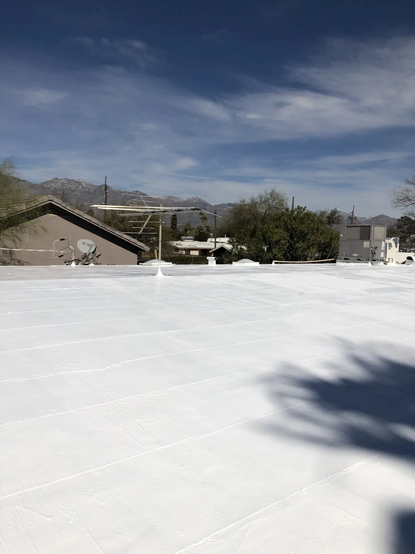 Cool roofing system on a flat roof in Tucson, Arizona — white reflective surface