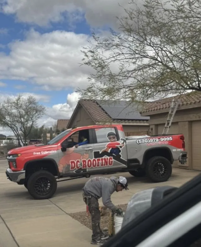 DC Roofing branded truck parked at a Tucson residential maintenance job