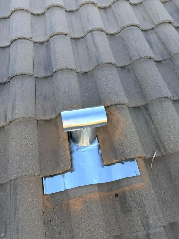 Completed pipe flashing repair through concrete tile roof in Tucson