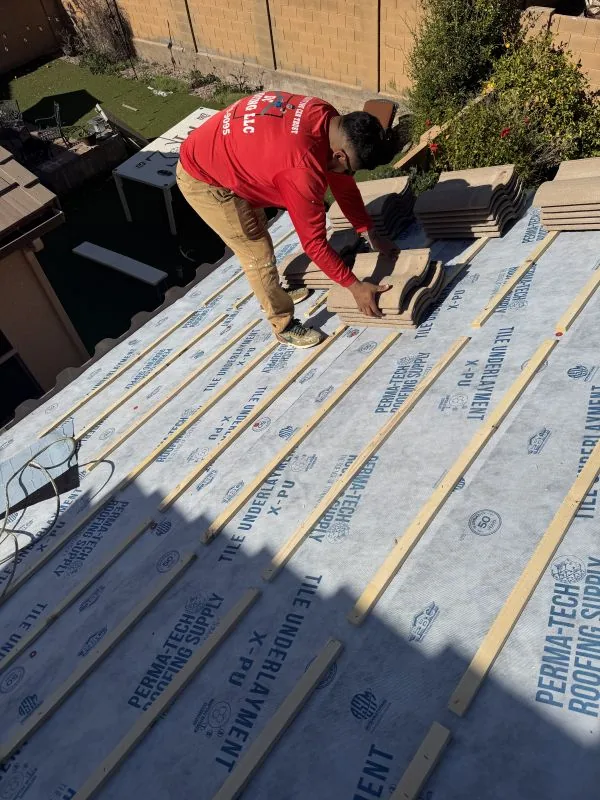 DC Roofing technician on a Tucson tile roof